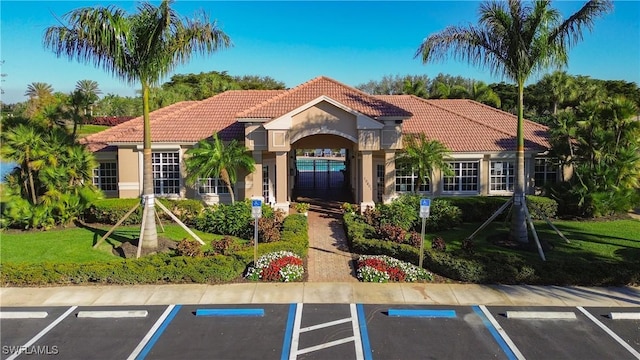 mediterranean / spanish house with a front yard