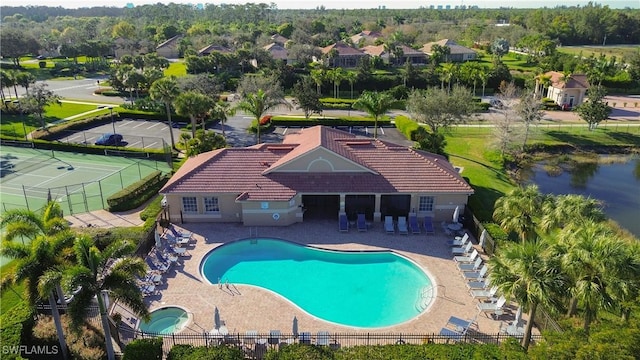 view of pool featuring a water view, a hot tub, and a patio area