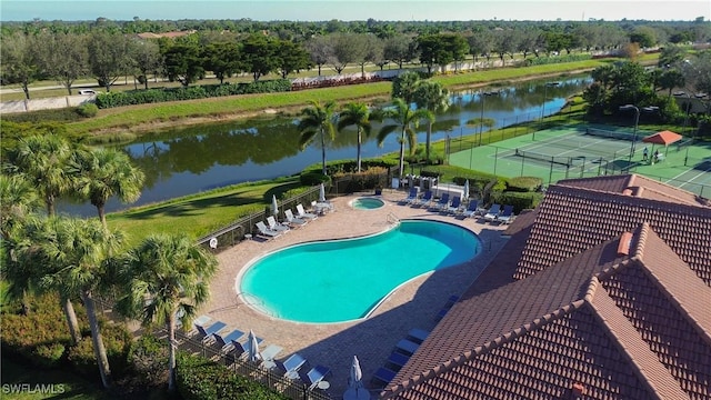 view of pool with a patio, a water view, and a community hot tub