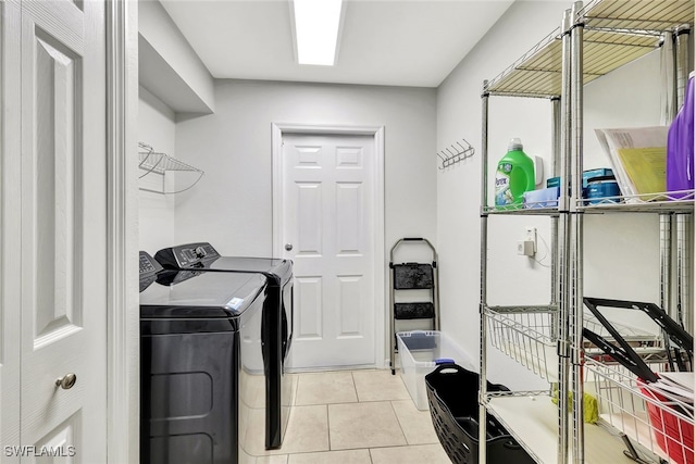 washroom with washing machine and dryer and light tile patterned floors