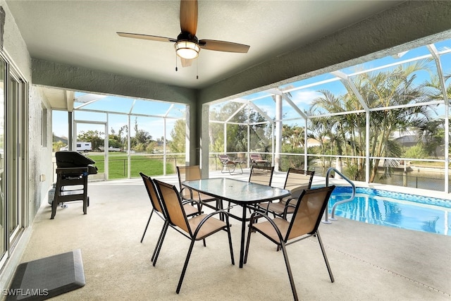 sunroom / solarium featuring ceiling fan and a swimming pool