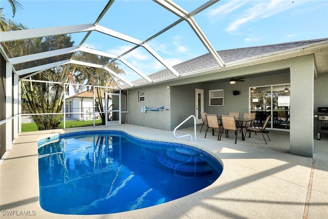 view of swimming pool with a patio, ceiling fan, and a lanai