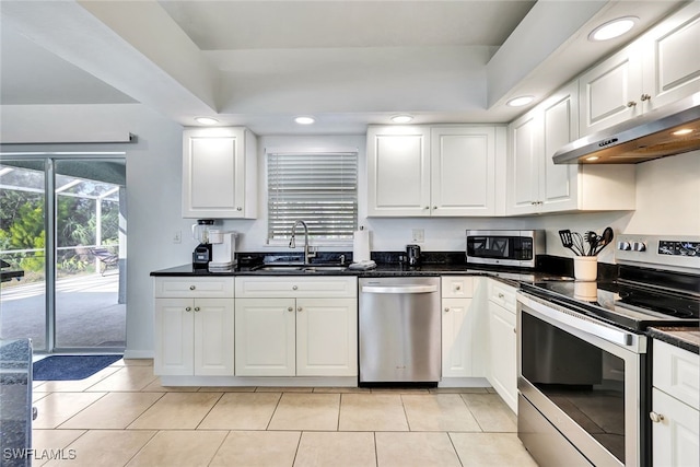 kitchen with dark stone countertops, sink, white cabinetry, and stainless steel appliances