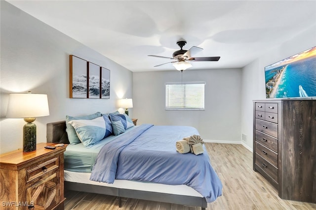 bedroom featuring light hardwood / wood-style floors and ceiling fan