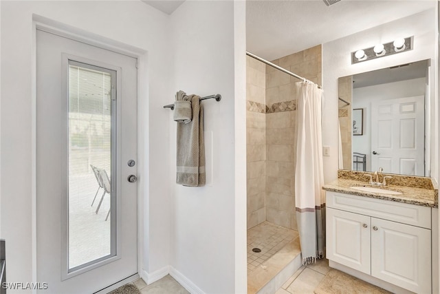 bathroom with tile patterned floors, a shower with curtain, and vanity