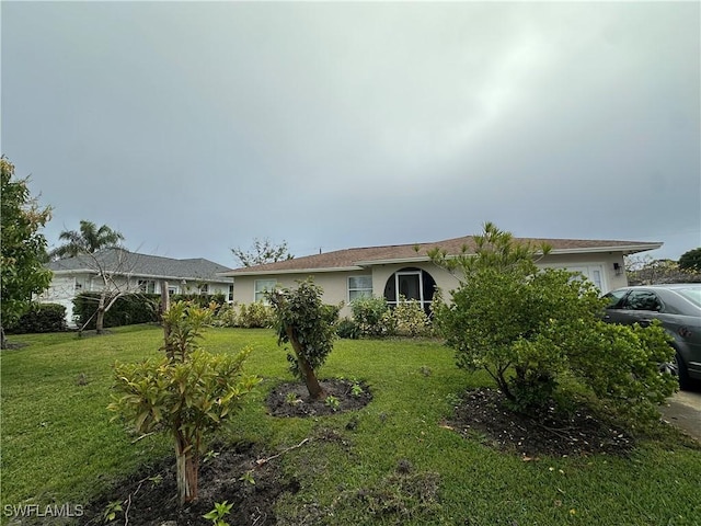 ranch-style home with a front yard and a garage