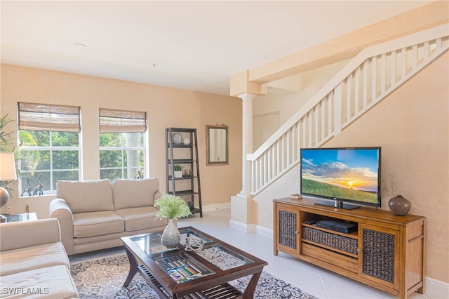 living room featuring light tile patterned floors and decorative columns