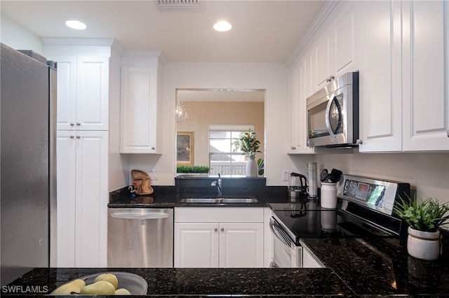 kitchen with white cabinetry, sink, dark stone counters, and appliances with stainless steel finishes