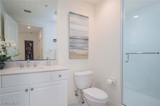 bathroom with a shower with door, vanity, and toilet