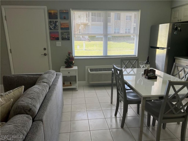 dining space with an AC wall unit, plenty of natural light, and light tile patterned floors