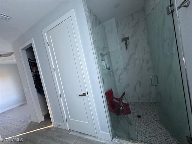 bathroom featuring a shower with shower door