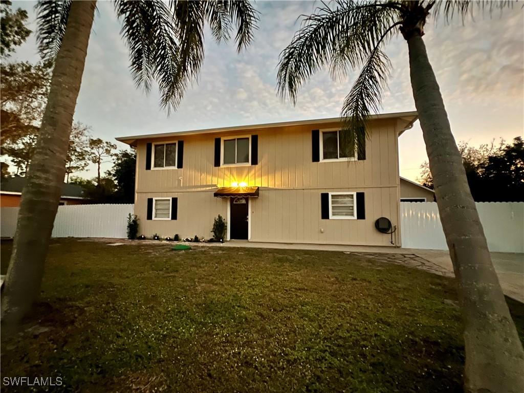 view of front facade with a patio and a yard