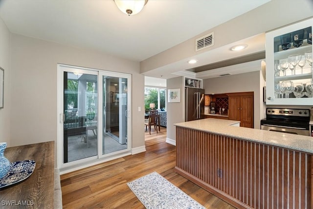 kitchen featuring appliances with stainless steel finishes, plenty of natural light, and hardwood / wood-style floors