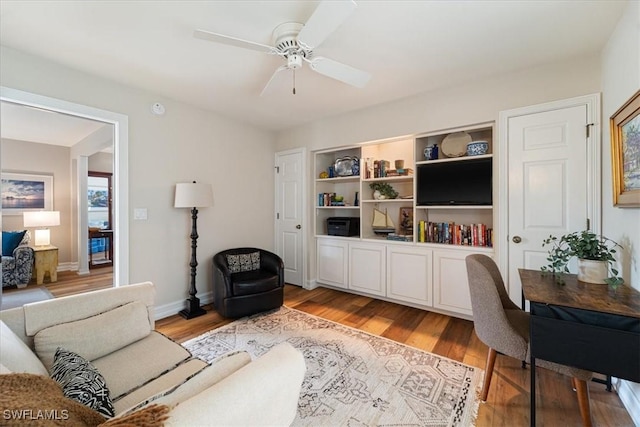 living room with ceiling fan and light hardwood / wood-style floors