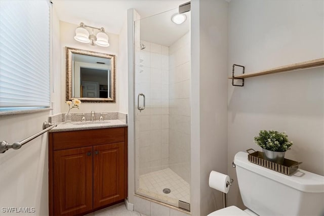 bathroom featuring toilet, an enclosed shower, and vanity