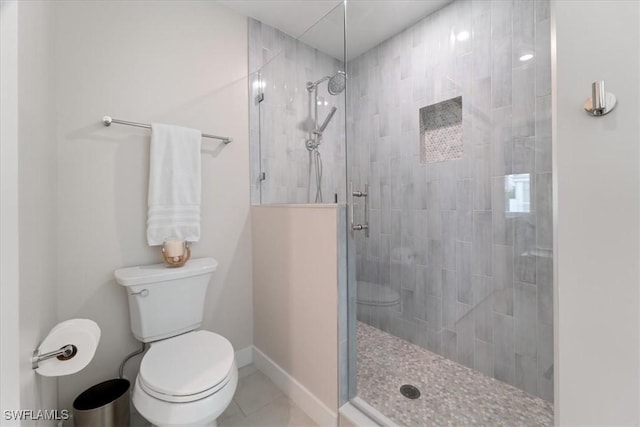 bathroom featuring an enclosed shower, toilet, and tile patterned flooring