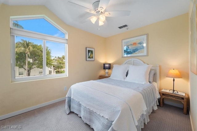 carpeted bedroom with vaulted ceiling and ceiling fan