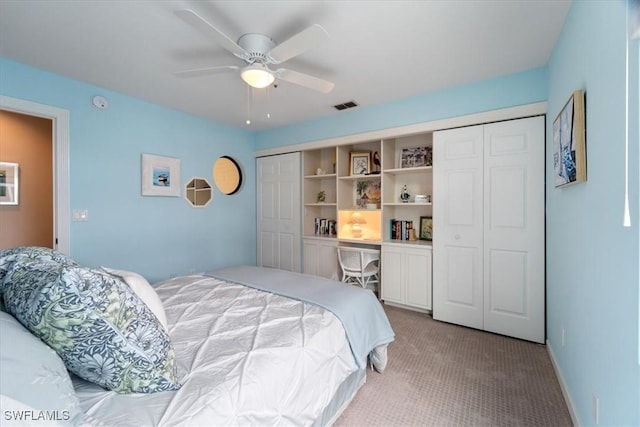 carpeted bedroom with ceiling fan and a closet