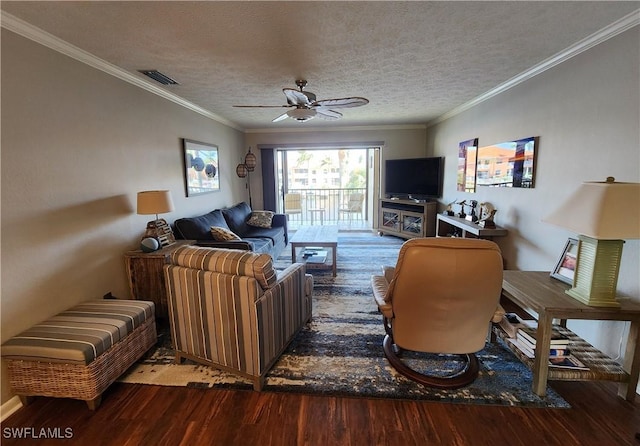 living room with ceiling fan, hardwood / wood-style floors, a textured ceiling, and ornamental molding