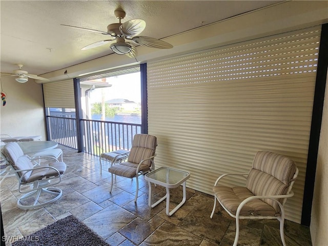 sunroom / solarium with ceiling fan