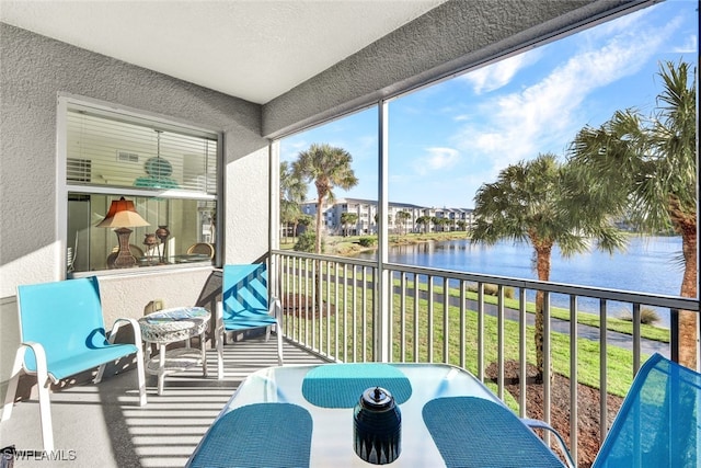 sunroom / solarium with a water view