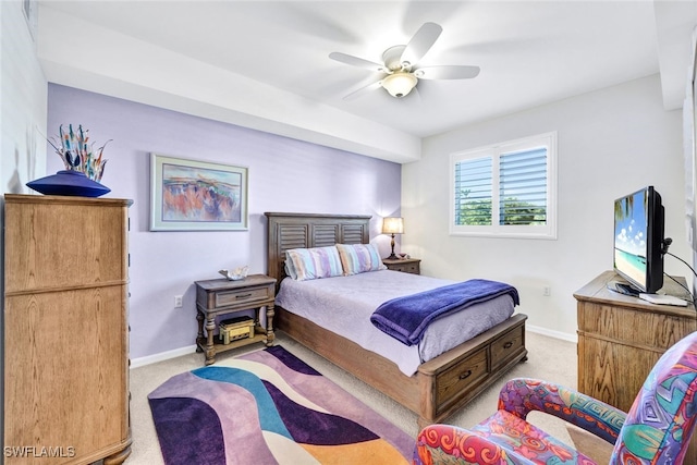 bedroom with ceiling fan and light carpet