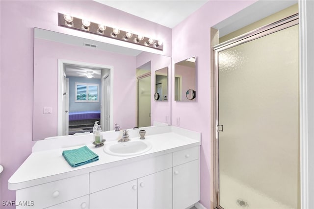 bathroom featuring vanity and an enclosed shower