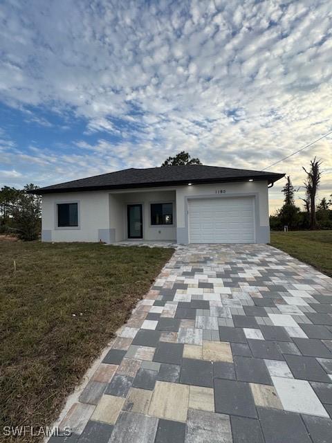 view of front facade with a garage and a front lawn