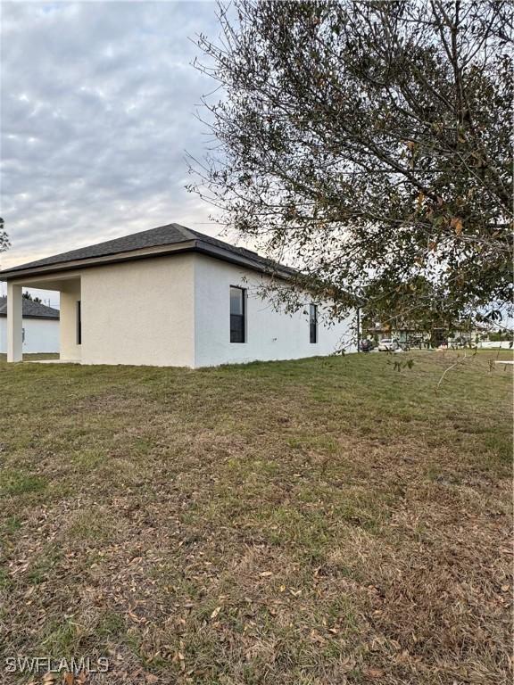 view of side of home featuring a lawn