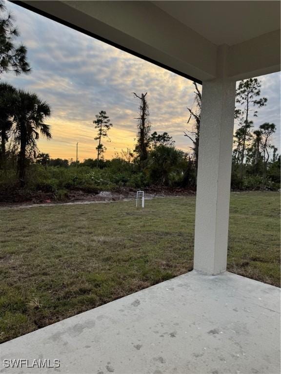 yard at dusk with a patio