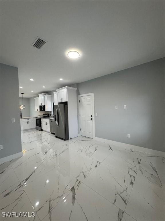 kitchen with sink, stainless steel appliances, white cabinetry, and pendant lighting