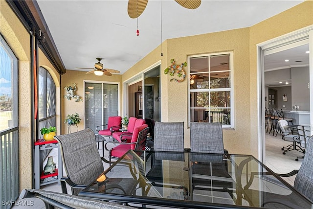 sunroom featuring a wealth of natural light and ceiling fan