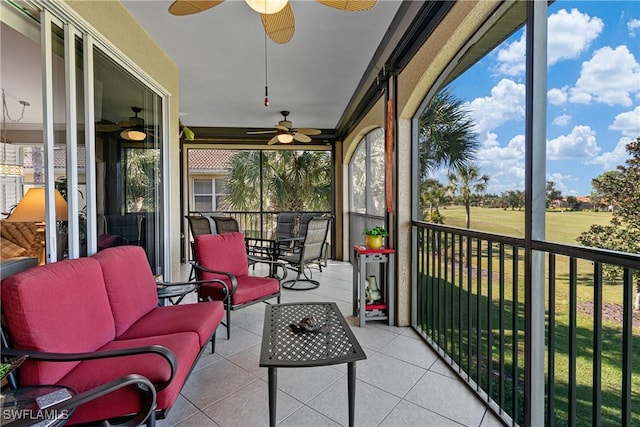 sunroom featuring ceiling fan