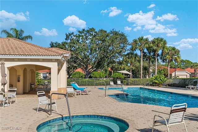 view of swimming pool with a patio and a hot tub