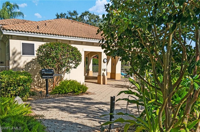 rear view of property featuring a patio area