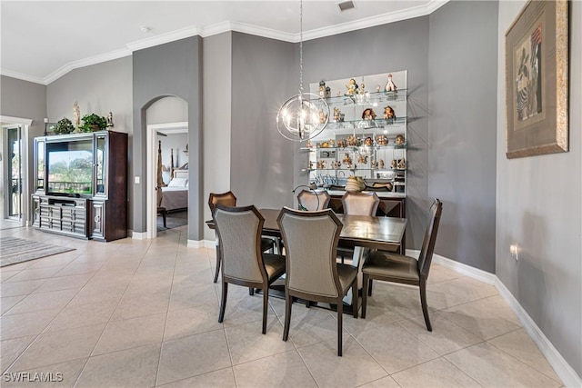 dining room with light tile patterned floors, a chandelier, and ornamental molding