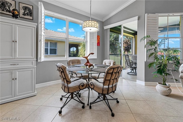 tiled dining room with plenty of natural light, lofted ceiling, and crown molding