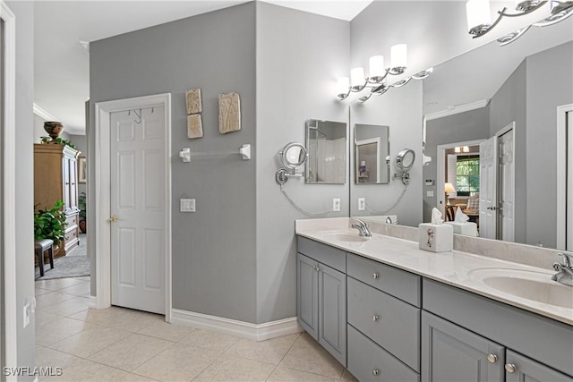 bathroom with tile patterned floors, vanity, and ornamental molding