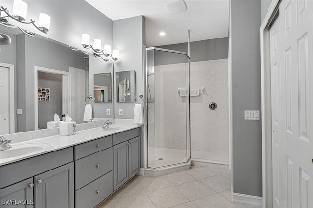 bathroom with tile patterned floors, vanity, and a shower with shower door