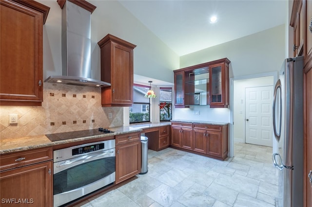 kitchen with light stone countertops, wall chimney exhaust hood, backsplash, lofted ceiling, and appliances with stainless steel finishes