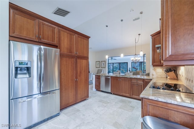 kitchen featuring pendant lighting, tasteful backsplash, a notable chandelier, kitchen peninsula, and stainless steel appliances