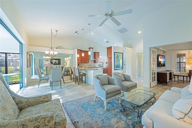 living room featuring ceiling fan with notable chandelier and lofted ceiling