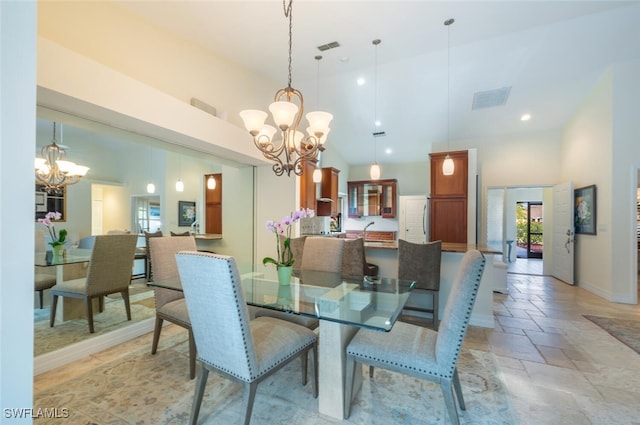 dining space featuring a notable chandelier and high vaulted ceiling