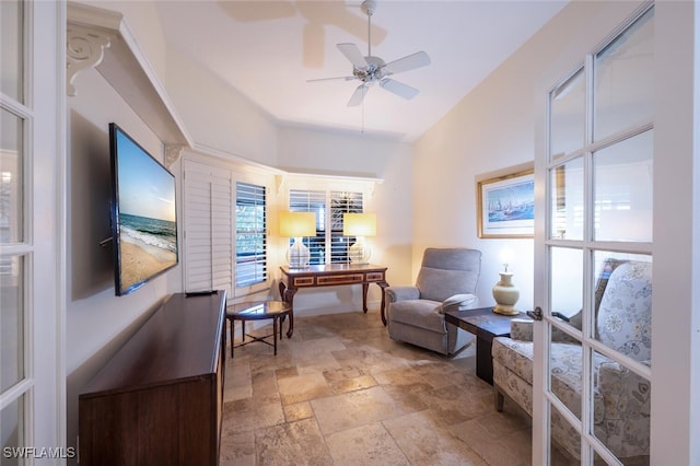 living area with french doors, ceiling fan, and lofted ceiling