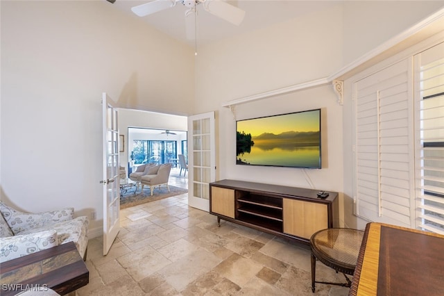 interior space featuring french doors, a towering ceiling, and ceiling fan