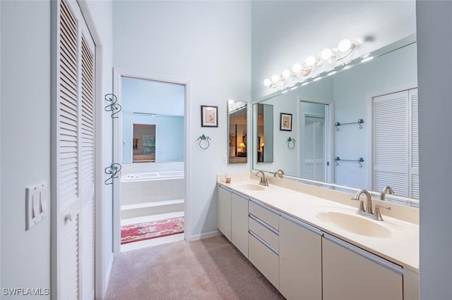 bathroom featuring vanity and tiled tub