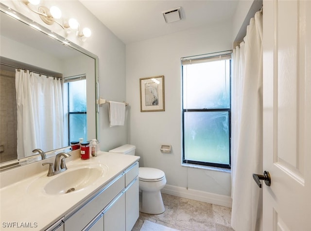 bathroom featuring vanity, a shower with shower curtain, and toilet