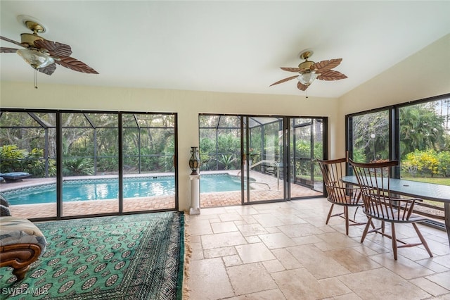 sunroom featuring ceiling fan and vaulted ceiling