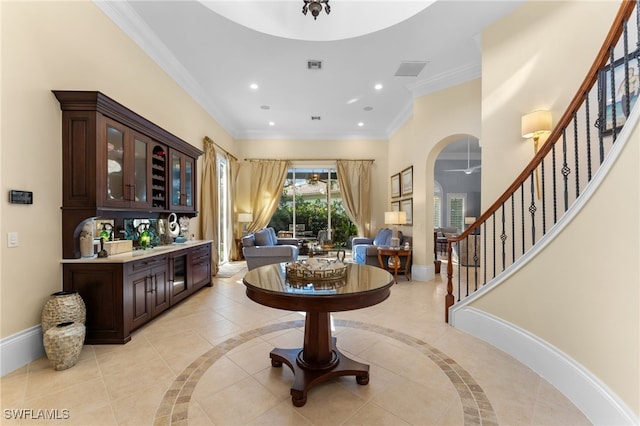 interior space featuring crown molding, dark brown cabinets, and ceiling fan