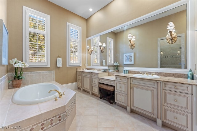 bathroom featuring tile patterned flooring, vanity, and separate shower and tub